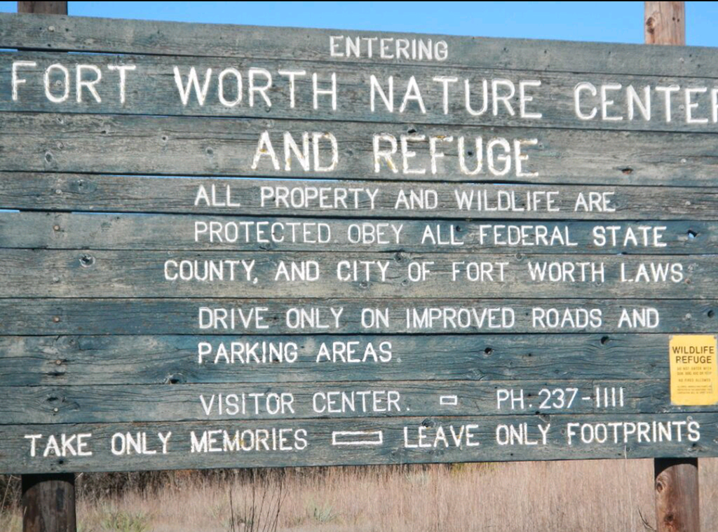 Weathered green sign at the Fort Worth Nature Center & Refuge